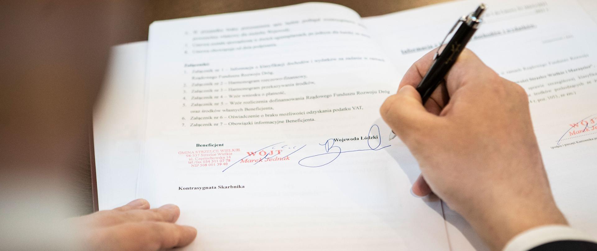 Wojewoda łódzki Tobiasz Bocheński składa swój podpis na umowie. 