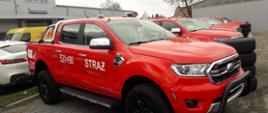 Na zdjęciu znajduje się lekki samochód rozpoznawczo-ratowniczy Ford Ranger dla Grupy Ratownictwa Technicznego, w tle salon motoryzacyjny.