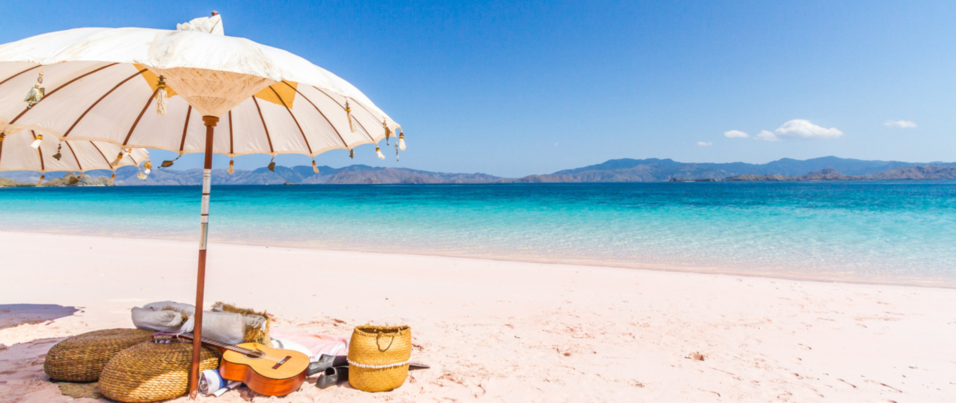 Miniatury: parasol rozłożony na plaży.