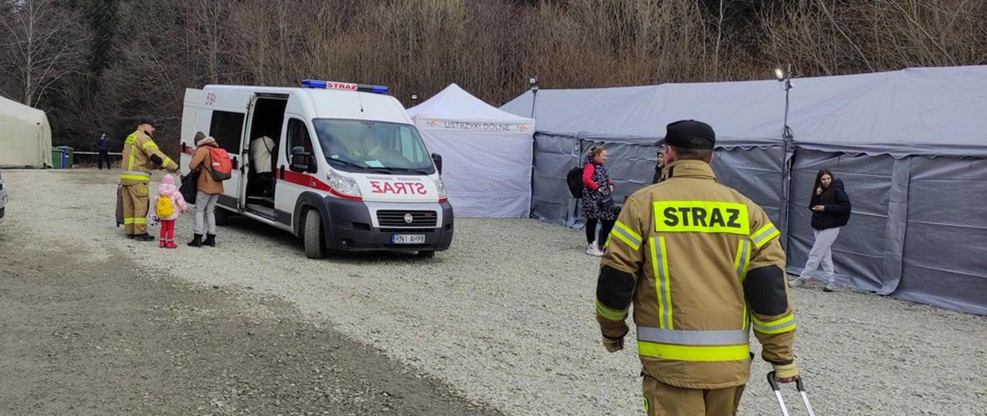 strażacy pomagają uchodźcom