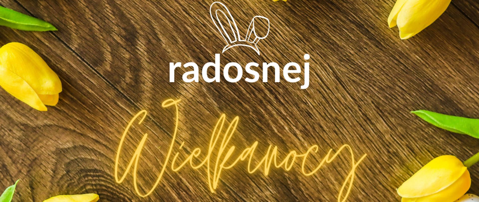 Na zdjęciu żółte tulipany i pomalowane jajka a na środku napis "Radosnej Wielkanocy"