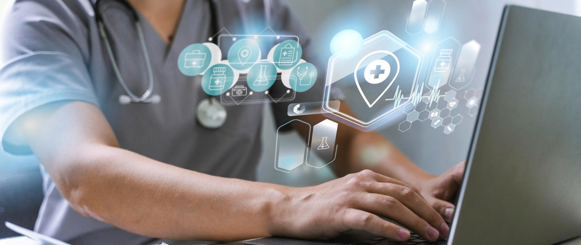 Zdjęcie lekarza siedzącego przy biurku z laptopem - nad laptopem ikonki z symbolami medycznymi