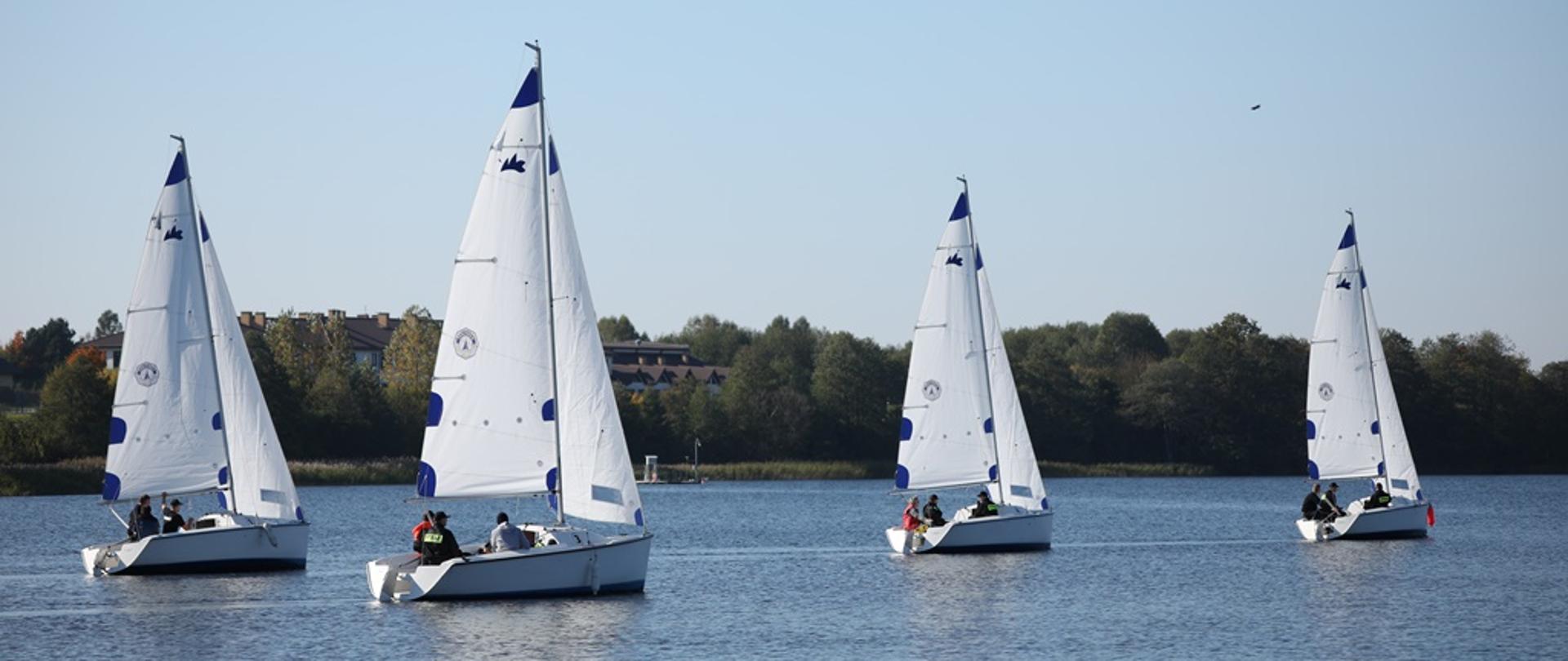 Żaglówki płynące po jeziorze w trakcie regat.