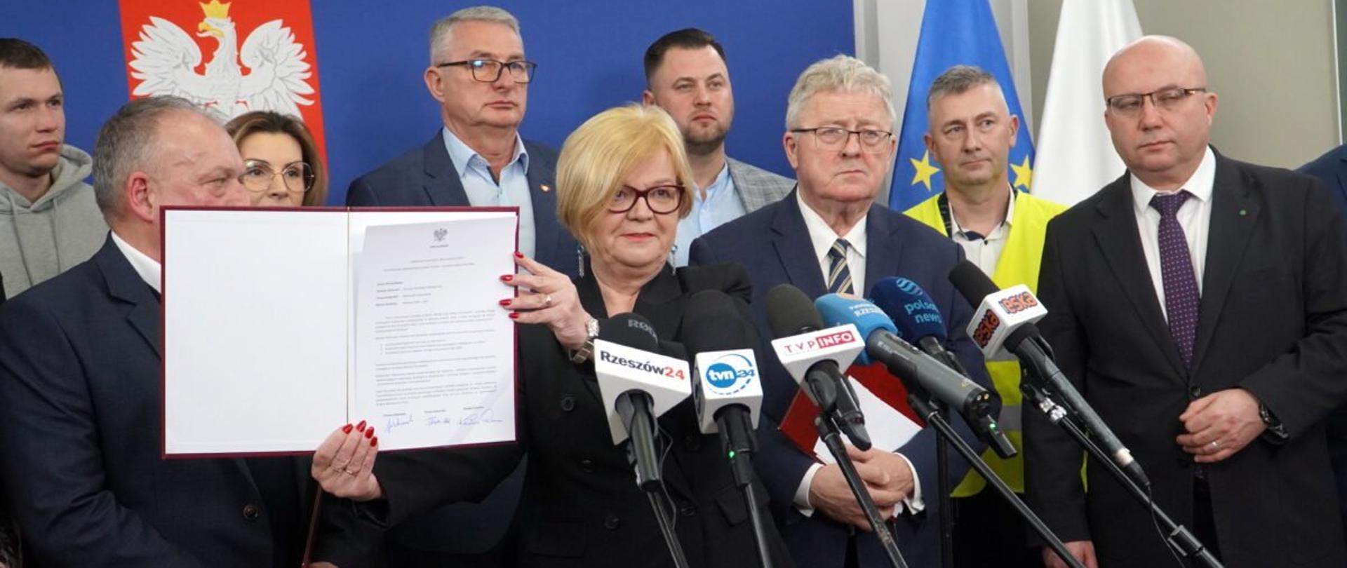 Wojewoda podkarpacki Teresa Kubas-Hul w otoczeniu uczestników konferencji prasowej trzymająca podpisane porozumienie z rolnikami