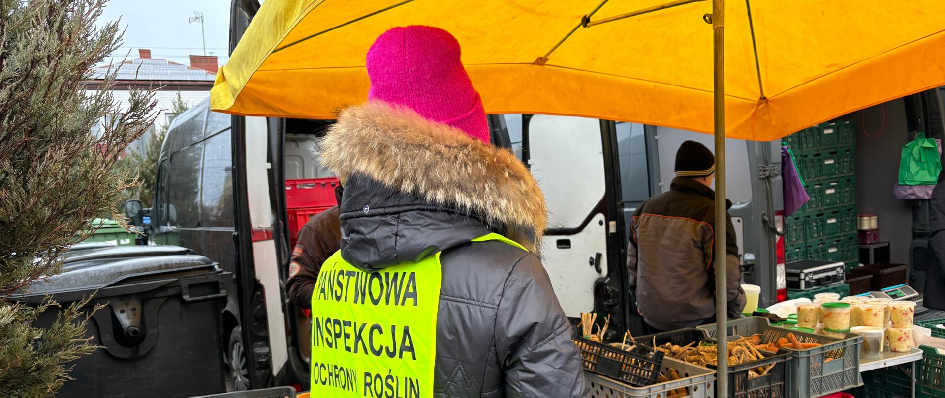 Akcja informacyjna na Targowicy Miejskiej w Augustowie- na zdjęciu pracownik WIORiN oddziału terenowego w Augustowie.