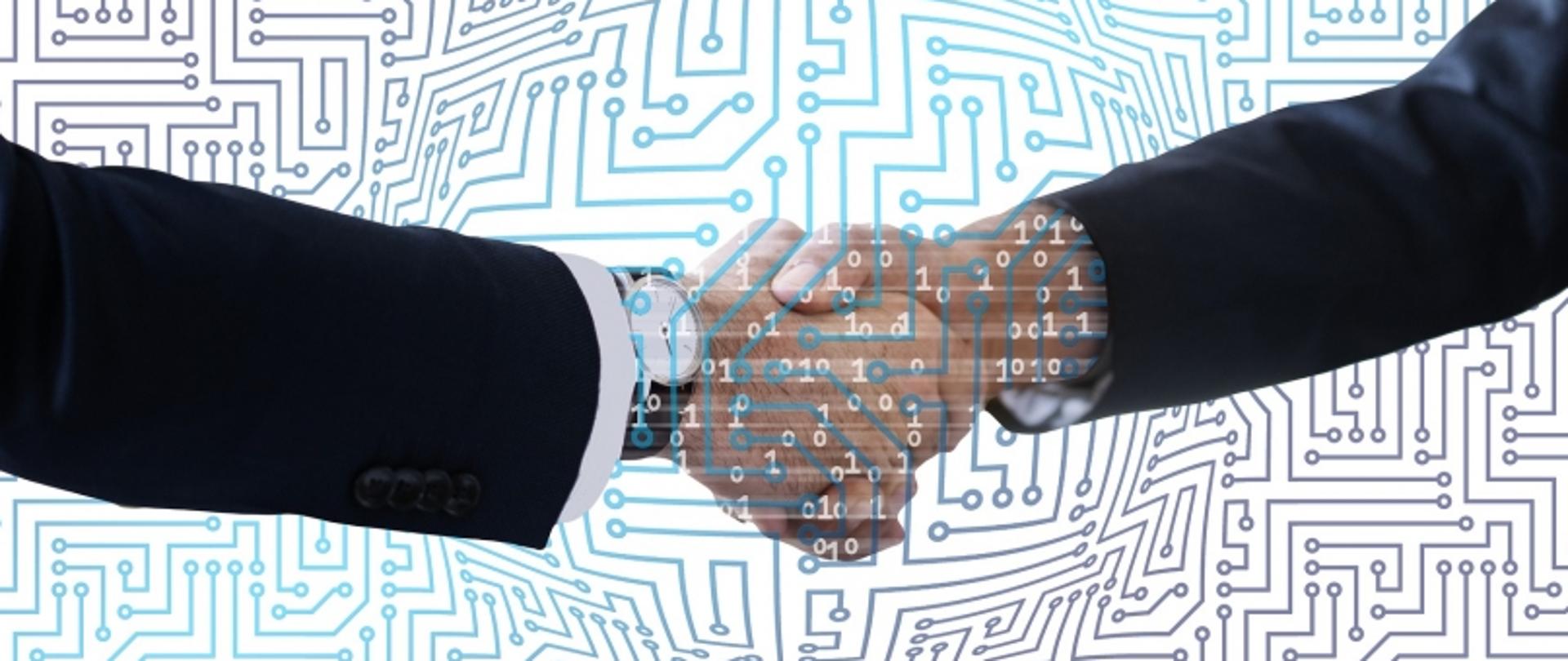 „Dwie osoby w garniturach ściskające dłonie, w tle układ scalony i liczby binarne.”