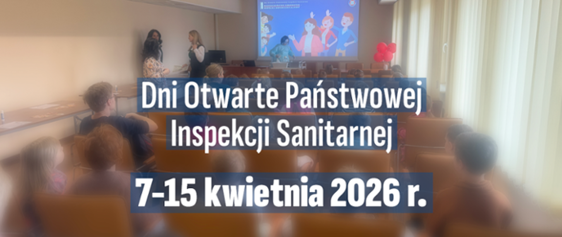 Zdjęcie przedstawia salę konferencyjną, w której odbywa się spotkanie edukacyjne w ramach Dni Otwartych Państwowej Inspekcji Sanitarnej. Na pierwszym planie widoczni są uczestnicy siedzący na krzesłach, zwróceni w stronę ekranu. Z przodu sali stoją dwie prowadzące, które omawiają prezentację wyświetlaną na dużym ekranie – widoczne są kolorowe grafiki postaci.
Na środku grafiki nałożony jest napis: „Dni Otwarte Państwowej Inspekcji Sanitarnej” oraz poniżej „7–15 kwietnia 2026 r.”. Po prawej stronie widoczne są okna z zasłonami oraz dekoracja z czerwonych balonów. Całość ma lekko rozmyte tło, z wyraźnie zaznaczonym tekstem informacyjnym na pierwszym planie.