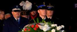 Przedstawiciele służb mundurowych oczekują na złożenie wieńca pod pomnikiem.