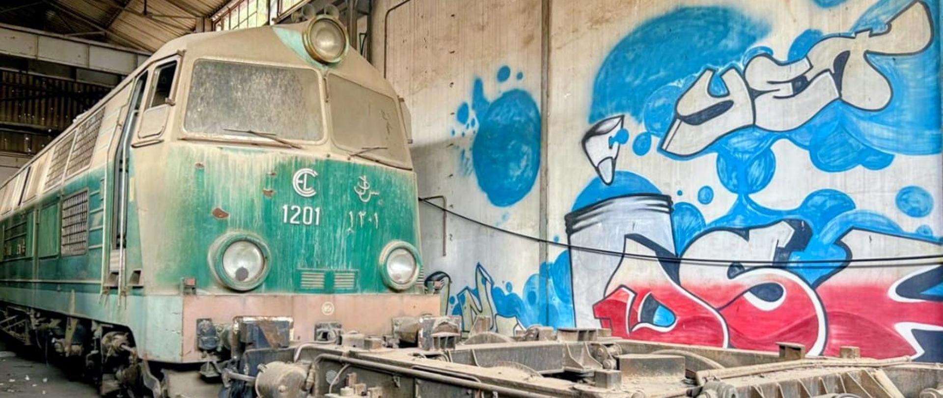 An old locomotive standing in a hangar