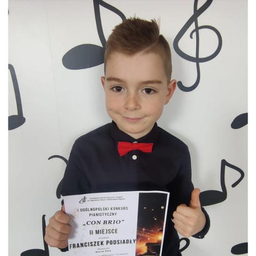 Zdjęcie Franka Podsiadły trzymający dyplom z konkursu Con Brio