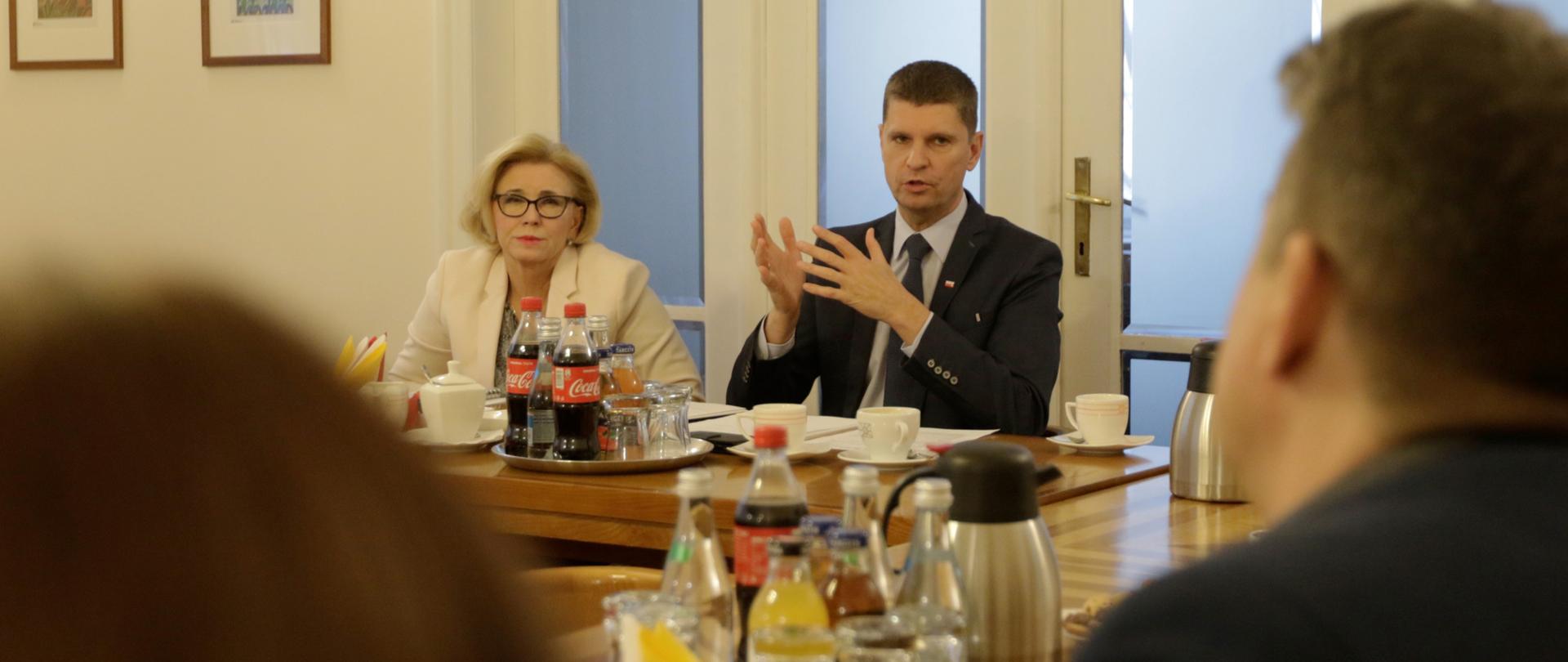 Minister edukacji rozmawia przy stole z członkami związku zawodowego Solidarność 