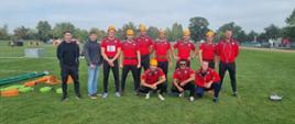 Na murawie boiska w czerwonych koszulkach pozują do zdjęcia 