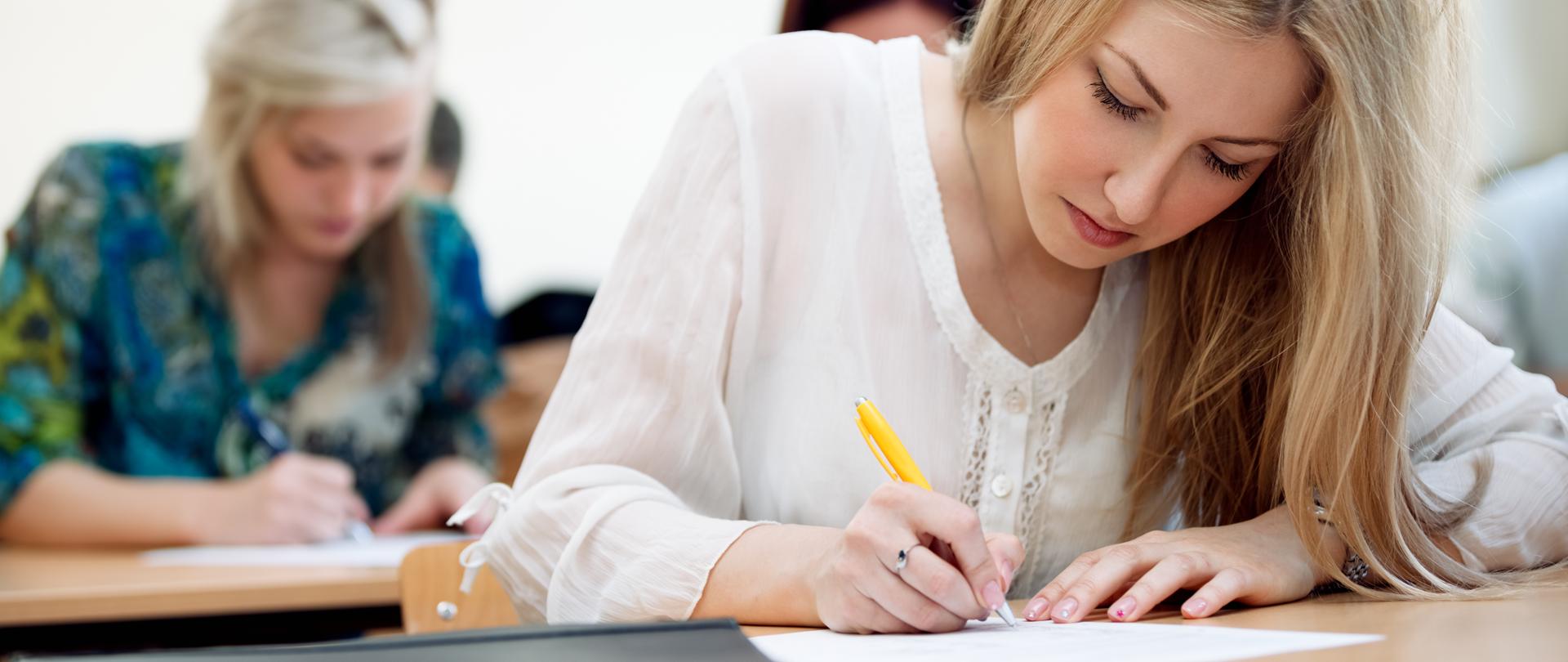 pretty female college student in a classroom