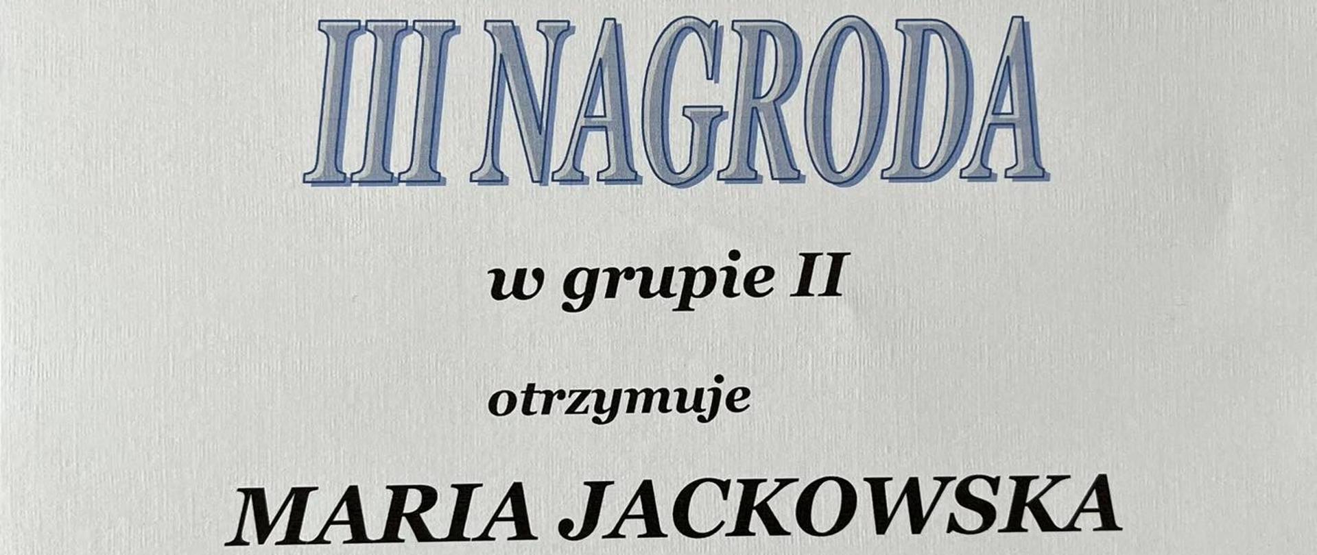Dyplom uczennicy za udział w konkursie. Czarne litery na białym tle.