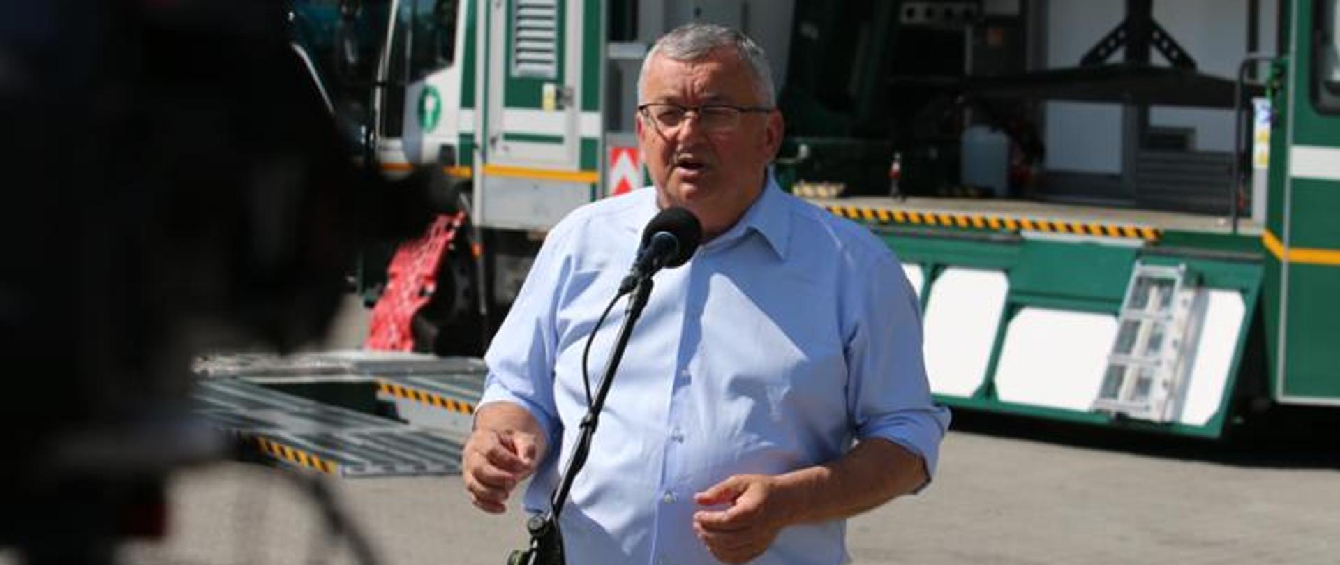 Jeden mężczyzna stojący przed mikrofonem i wypowiadający się 