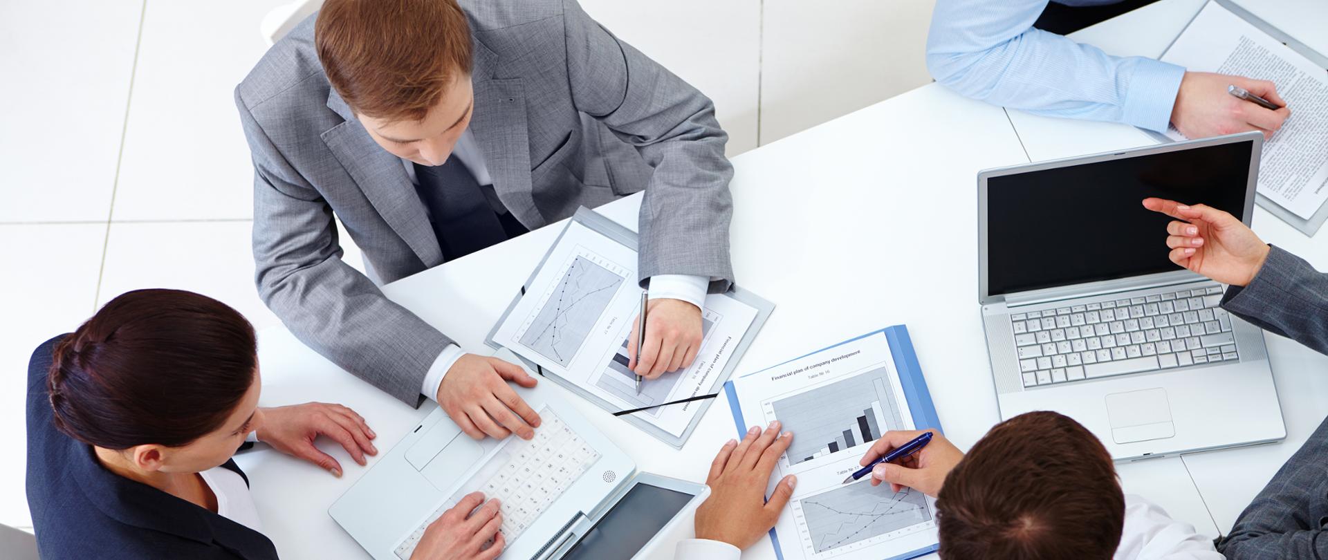 Above view of business team sitting around table and working