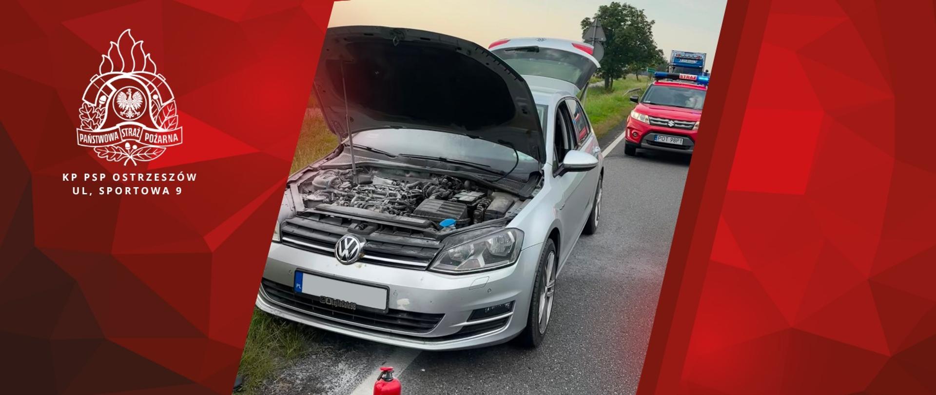 Na zdjęciu przód samochodu który gasili strażacy. Na drugim planie samochód operacyjny straży pożarnej, w oddali ciężarówka.