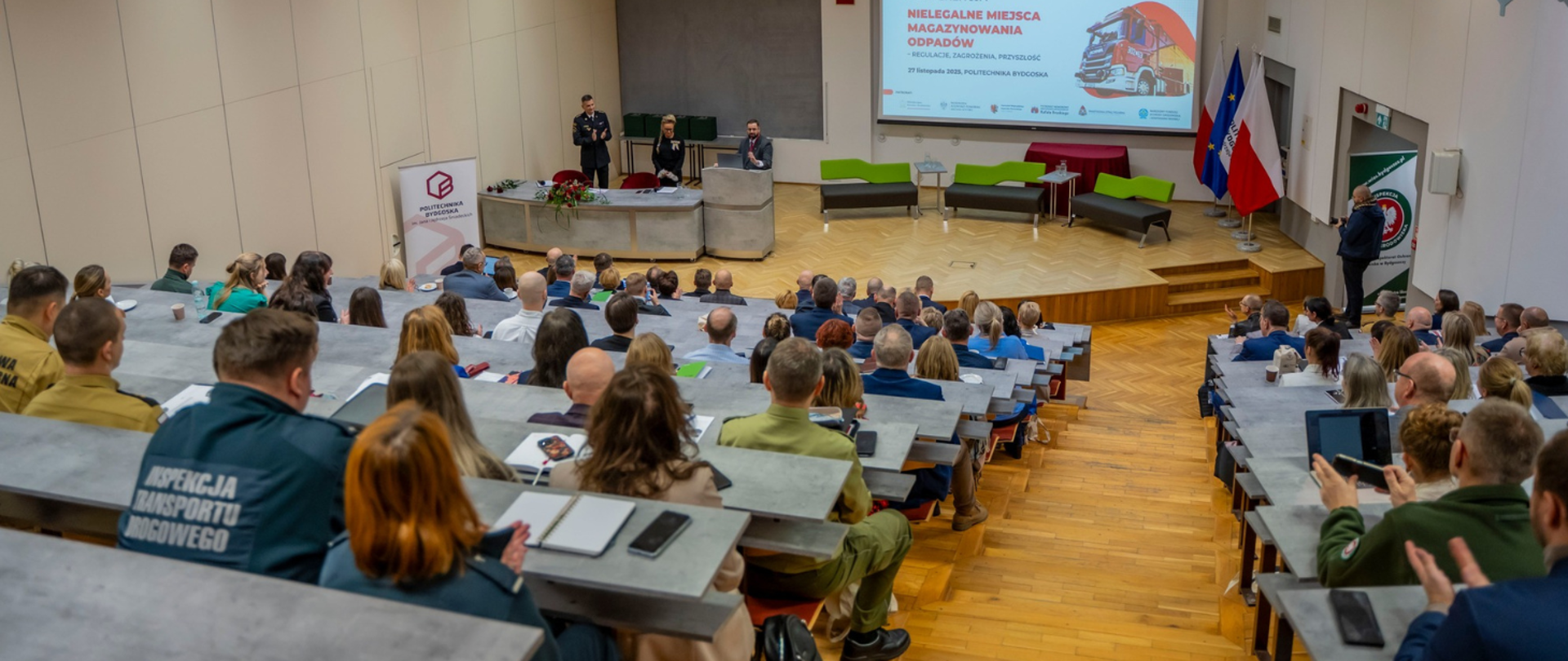 Uczestnicy konferencji „Nielegalne miejsca magazynowania odpadów – regulacje, zagrożenia, przyszłość” siedzą w auli Auditorium Novum PBŚ.