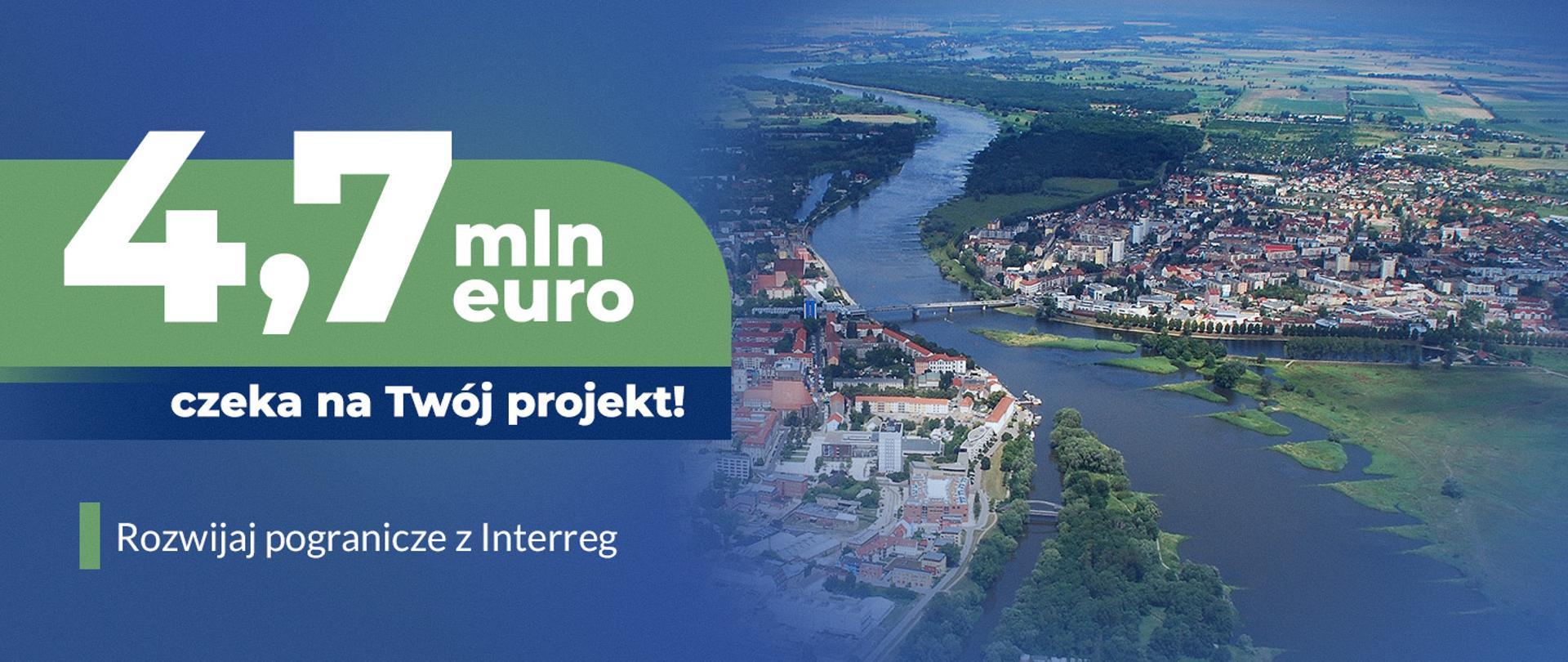 Grafika przedstawia miasto przedzielone rzeką i połączone mostem