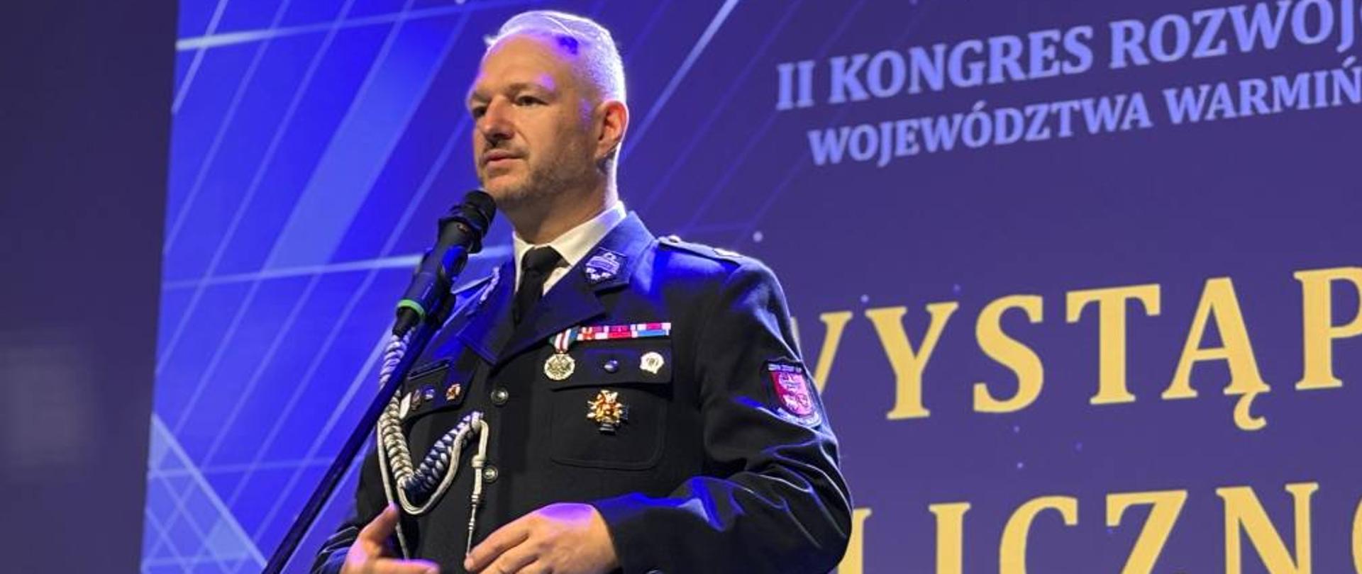 Wojewoda w mundurze przemawia ze sceny 