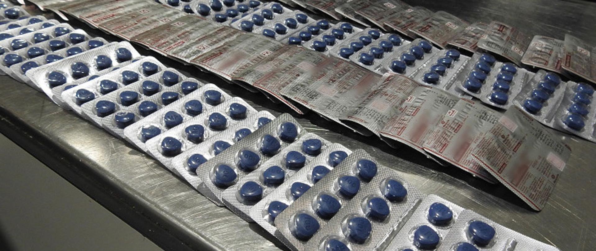 Blistry tabletek rozłożone na stole.