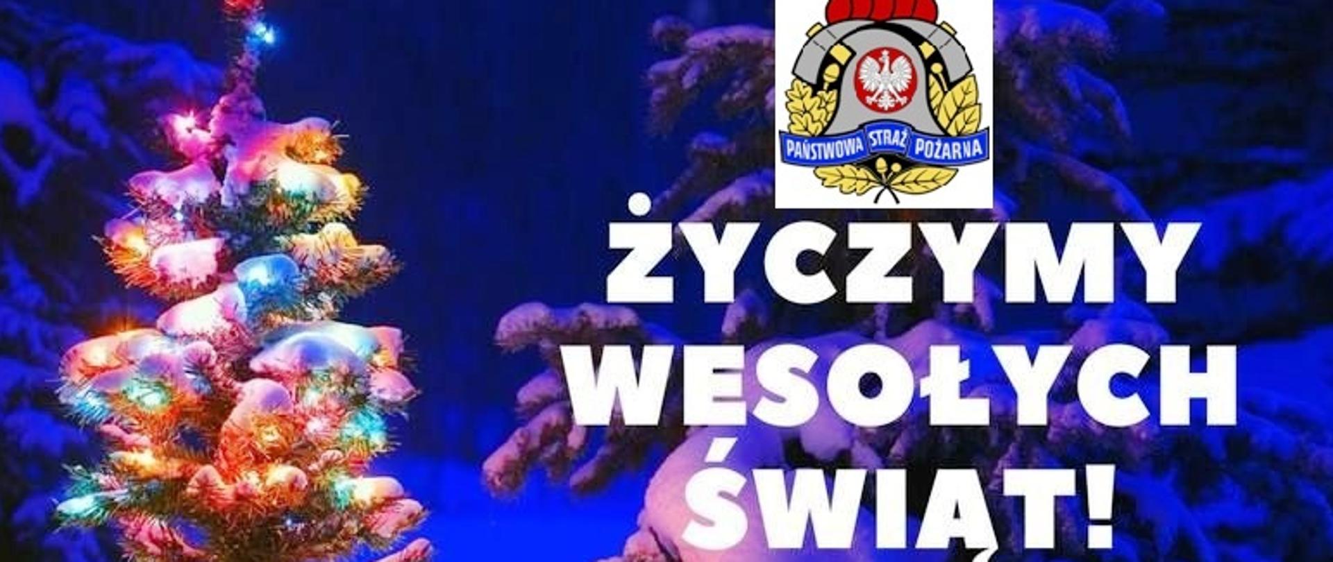 Kolorowa fotografia przedstawiająca ośnieżone choinki na niebieskim tle. Po lewej stronie choinka w kolorowych światełkach. Po prawej od góry: kolorowe logo Państwowej straży Pożarnej na białym prostokącie, poniżej biały napis tłustym drukiem w trzech wersach o treści: Życzymy Wesołych Świąt!, a poniżej biały napis drobnym drukiem w kilku wersach o treści: Z okazji Świąt Bożego Narodzenia oraz nadchodzącego Nowego 2021 Roku życzymy wiele radości, dużo zdrowia i rodzinnego ciepła w Waszych domach. W Nowym Roku niech spełniają się Wasze plany w życiu prywatnym i służbowym. Poniżej podpis o treści: Komendant Powiatowy Państwowej Straży Pożarnej w Brzozowie st. bryg. Krzysztof Folta wraz ze strażakami i pracownikami cywilnymi.