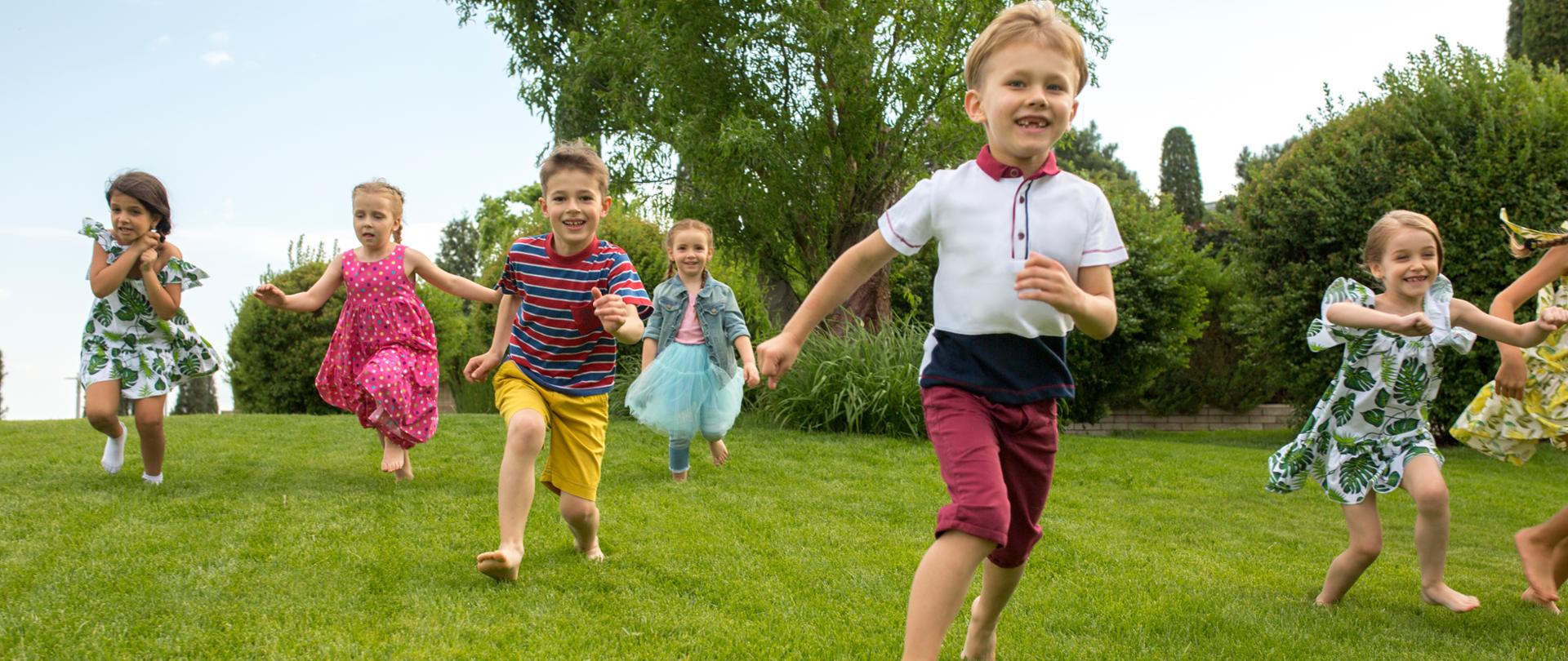 Funny starts. Kids fashion concept. The group of teen boys and girls running at park. Children colorful clothes, lifestyle, trendy colors concepts.