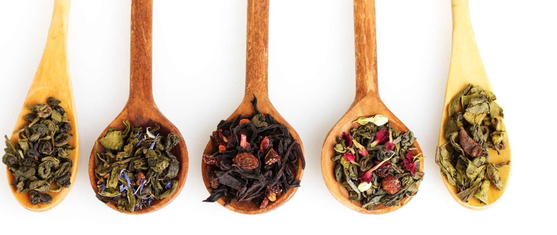 różne rodzaje herbaty na drewnianych łyżeczkach
