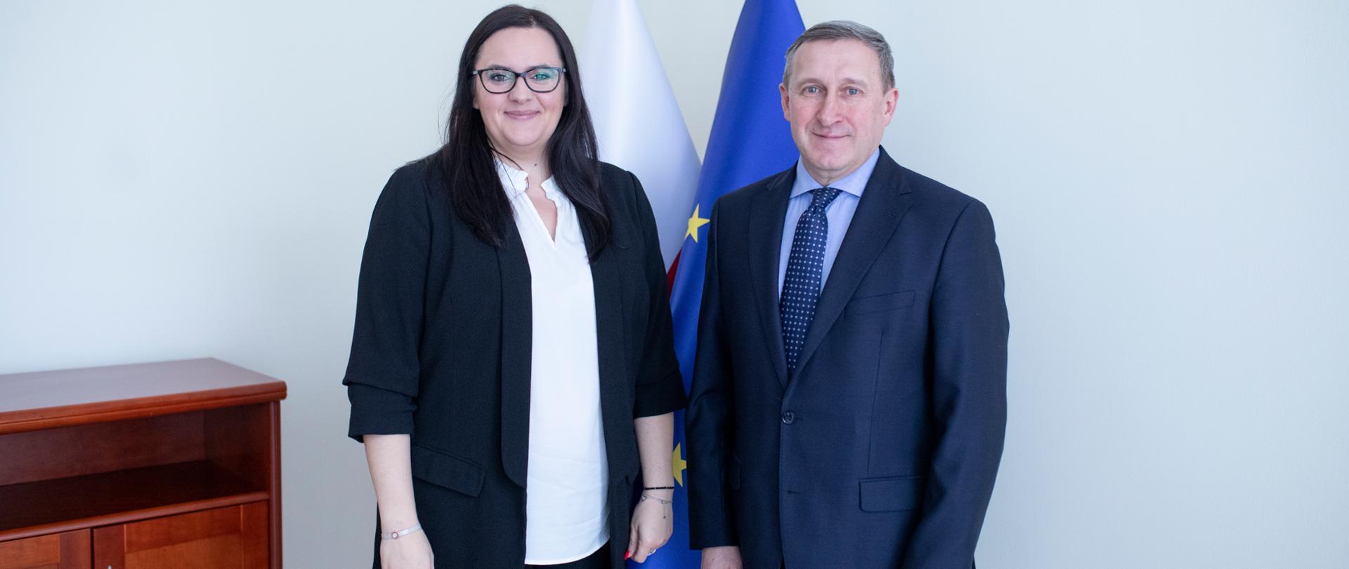 Na tle dwóch flag Polski i UE stoi minister Małgorzata Jarosińska-Jedynak oraz ambasador Ukrainy w Polsce Andrij Deszczyca