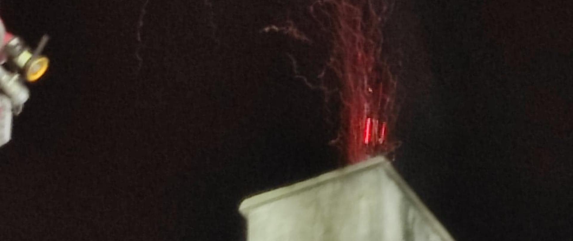 Zdjęcie obrazu pożar sadzy w przewodzie dymowym i unoszące się iskry, które stwarzają zagrożenie zapalenia się dachu
