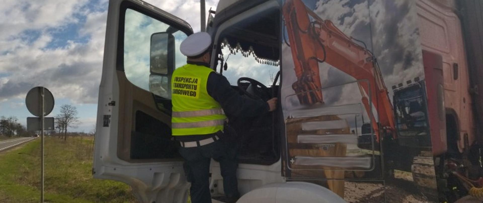 Inspektor wchodzący do kabiny pojazdu