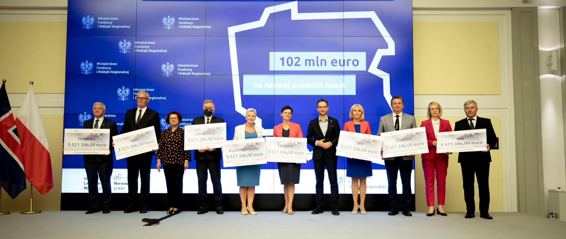 Zdjęcie grupowe przedstawiające ministra Waldemara Budę, oraz 8 włodarzy miast z czekami o wartości 3,5 mln euro.