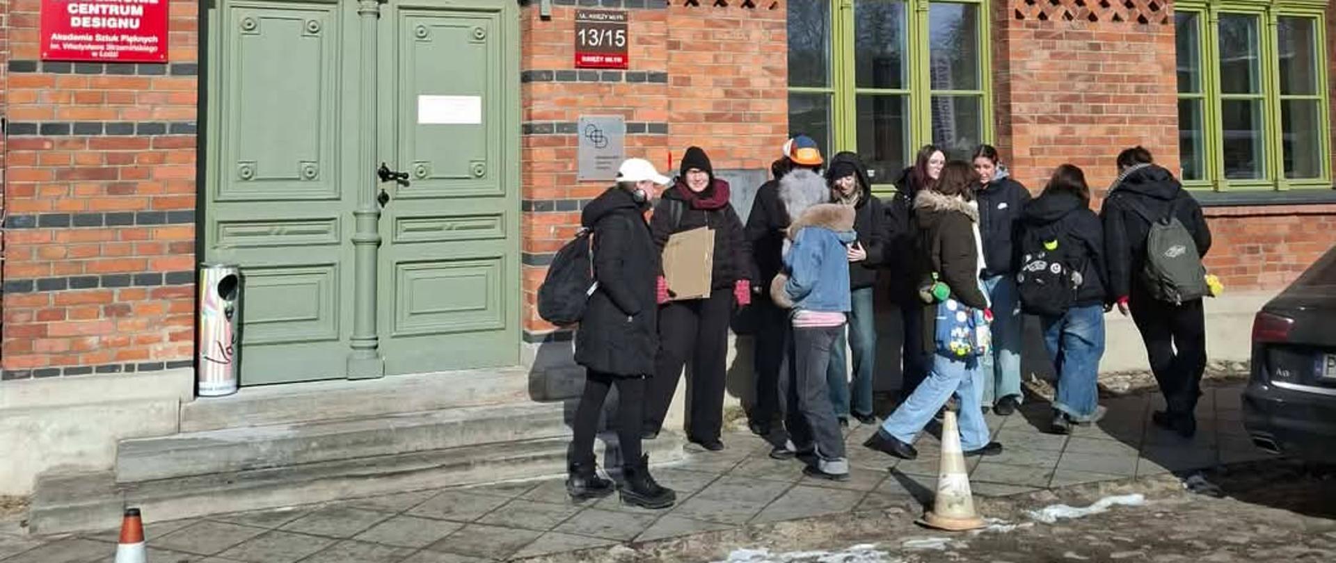 Na zdjęciu grupa uczniów przed wejście do Akademickiego Centrum Designu