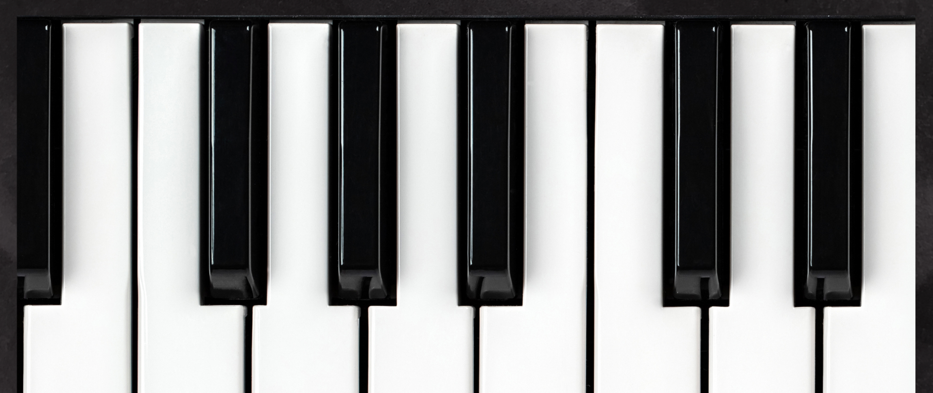 Na plakacie widnieją czarno białe klawisze fortepianu