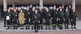 Grupowe zdjęcie uczestników szkolenia w towarzystwie Zastępcy Komendanta Centralnej Szkoły PSP oraz Zastępcy Naczelnika Wydziału Szkoleń Specjalistycznych i Współpracy Międzynarodowej