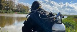 Nurek ubrany w sprzęt nad brzegiem zbiornika wodnego