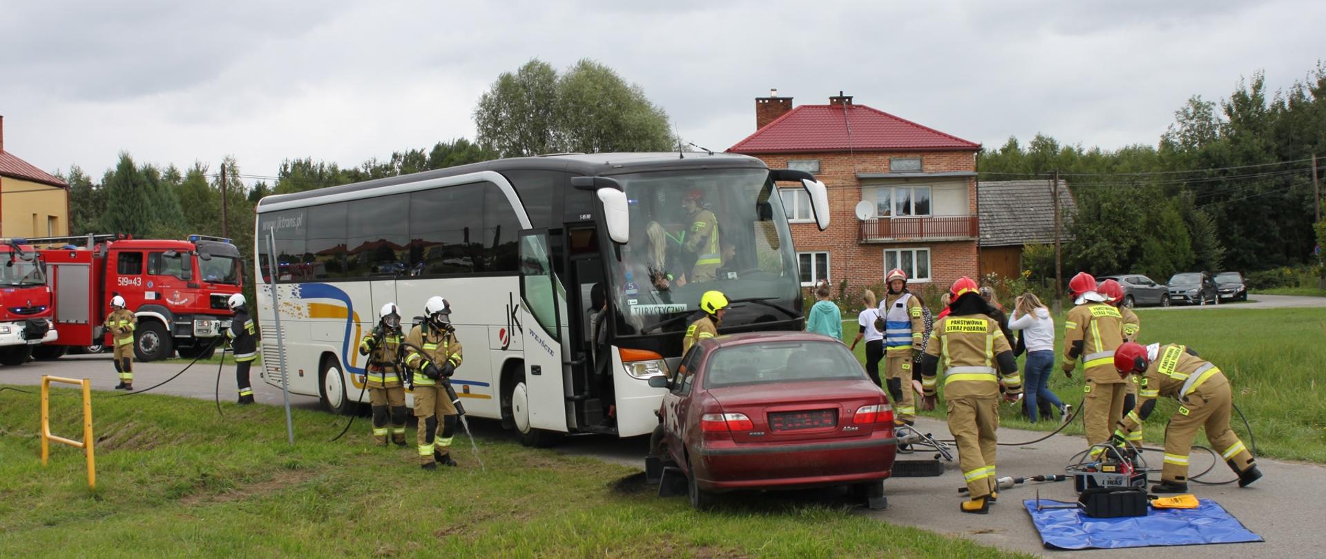 strażacy pomagają poszkodowanym w wypadku