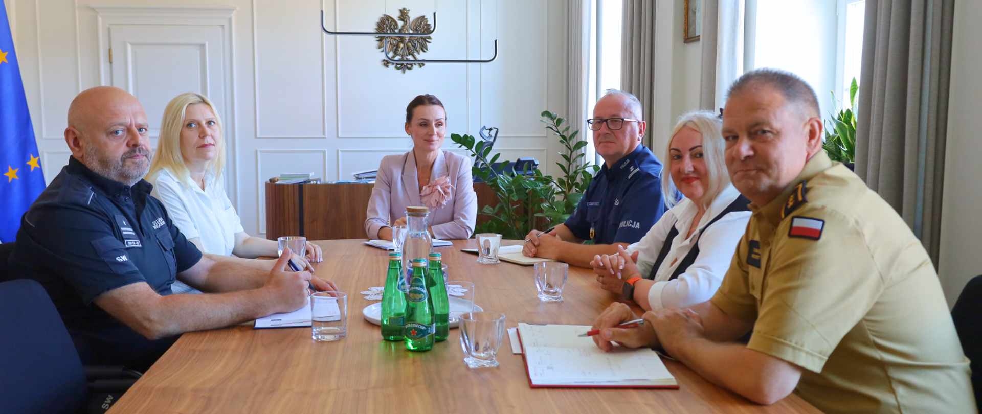 kilka osób siedzi przy stole i rozmawia