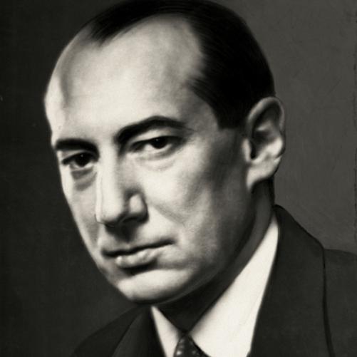 Józef Beck - półprofil mężczyzny, ciemne włosy, ciemne brwi, ciemna marynarka, ciemny krawat w jasne grochy, biała koszula.