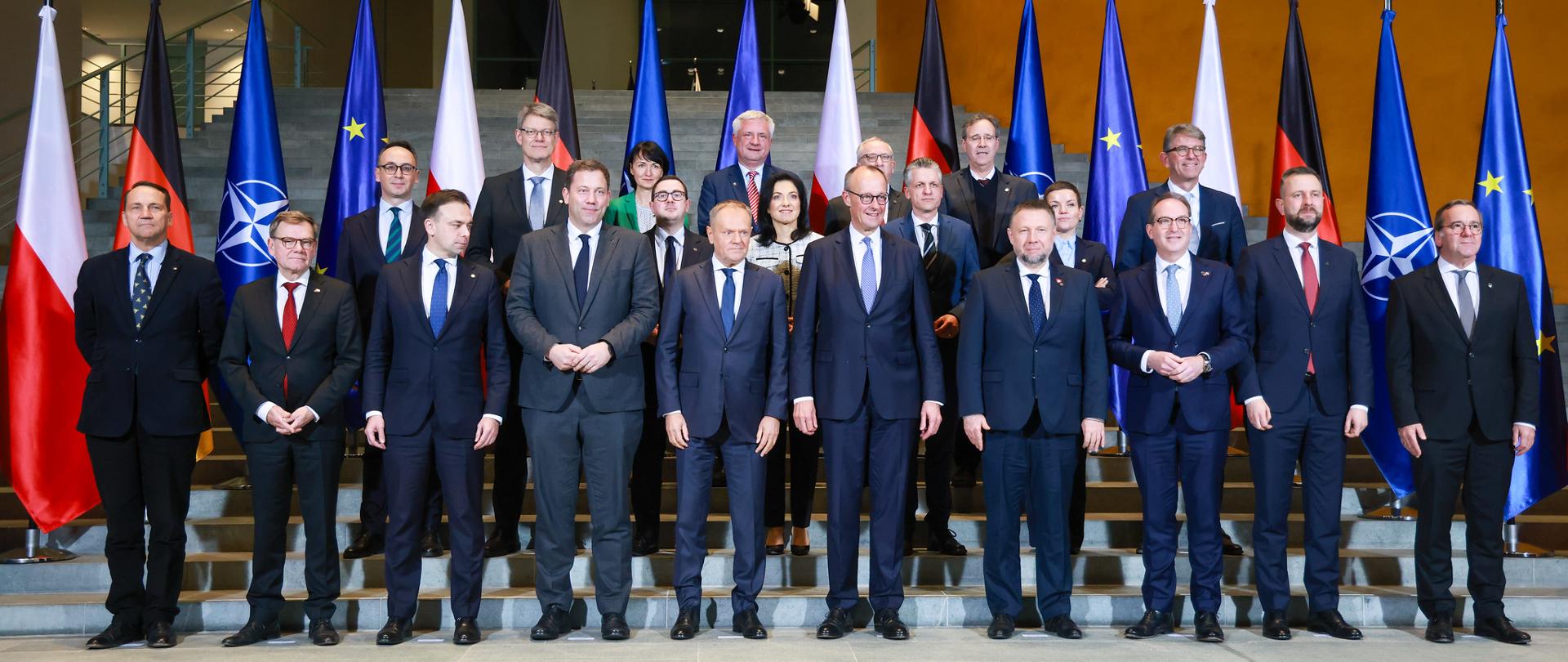 Ministers in formal clothing posing to a family photo