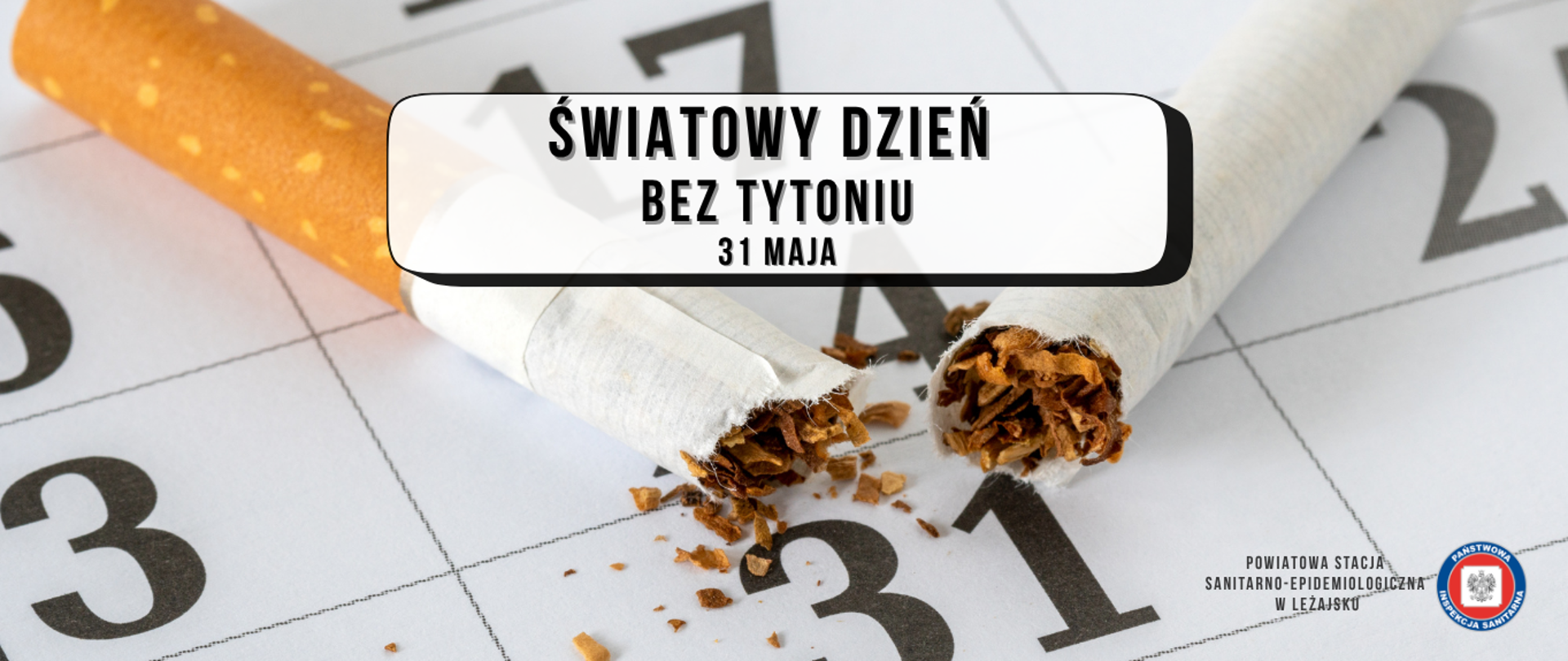 Zdjęcie przedstawia połamanego papierosa na kartce z kalendarza 