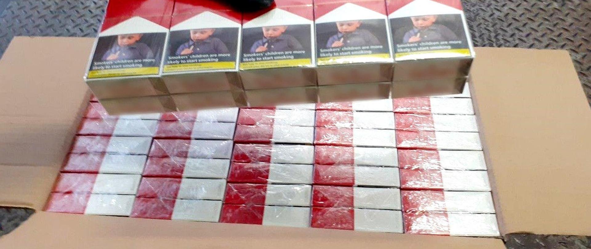Otwarte pudło z papierosami z przemytu.