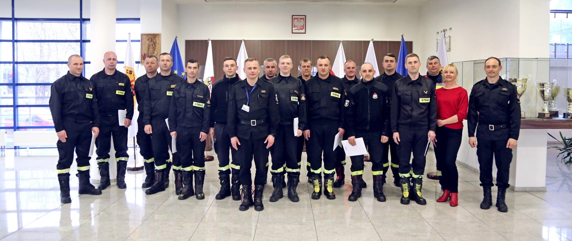 Grupowe zdjęcie uczestników szkolenia w towarzystwie Zastępcy Komendanta Centralnej Szkoły PSP, pracownicy wydziału szkoleń specjalistycznych i współpracy międzynarodowej oraz zastępcy naczelnika wydziału technicznego