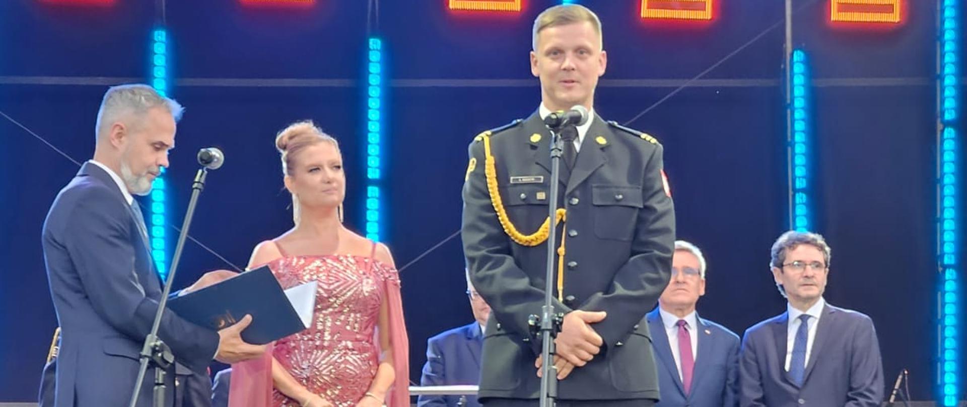 Na tym zdjęciu widzimy strażaka, który przemawia po odebraniu odznaczenia.