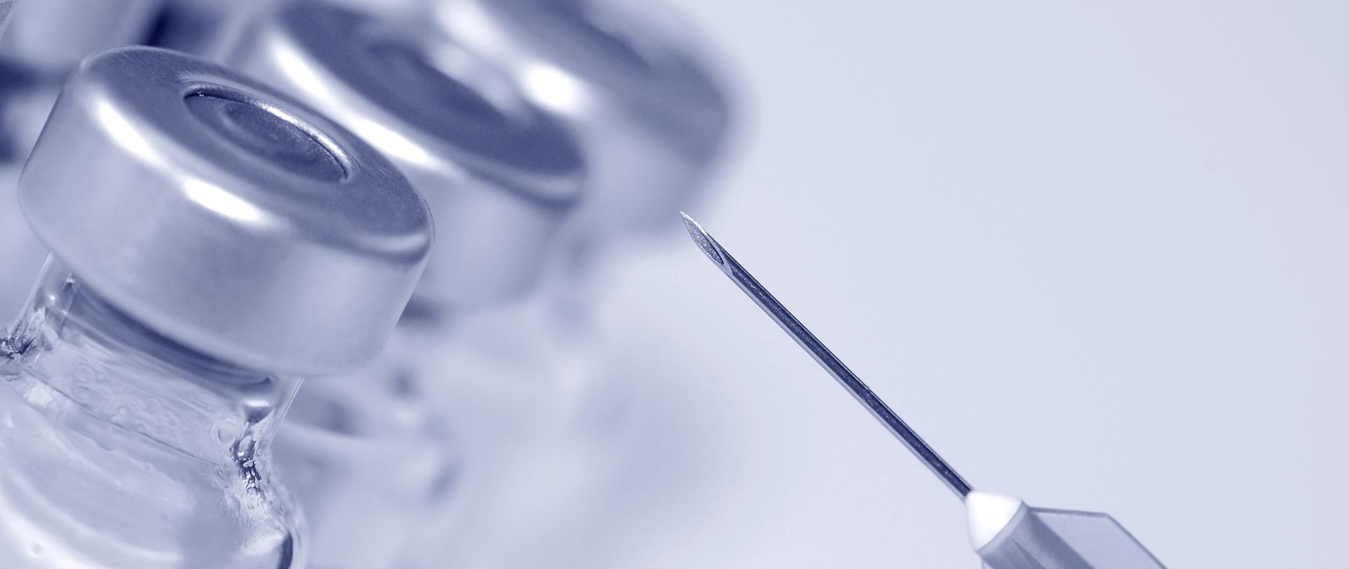 close-up of syringe needle and glass phials