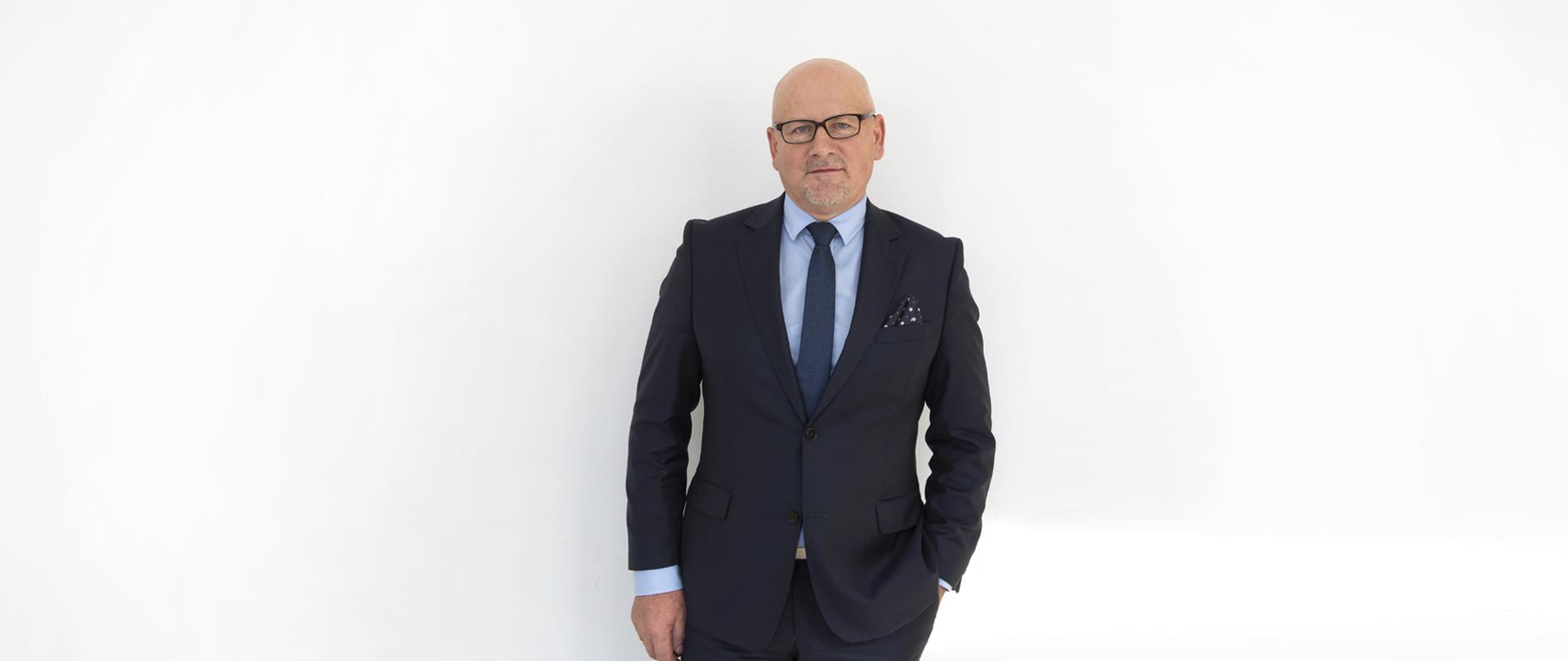 Andrzej Długołęcki, p.o. Zastępca Dyrektora ds. Ekonomiczno-Administracyjnych WSSE w Warszawie, portret mężczyzny w ciemnym garniturze, połowa sylwetki