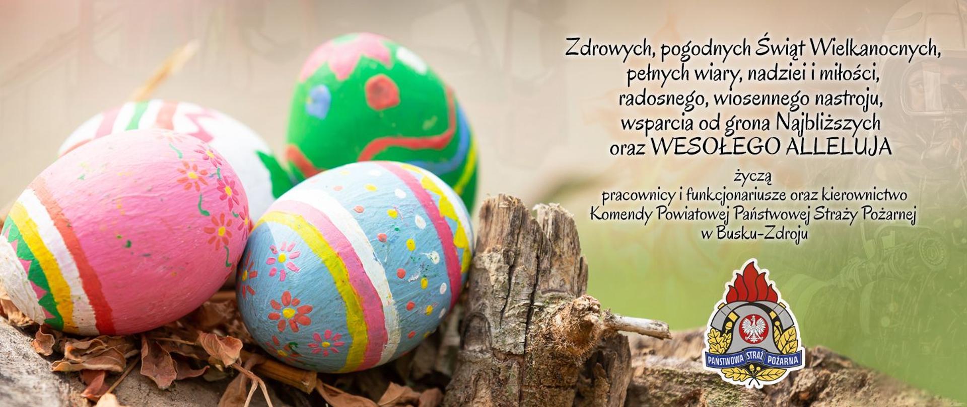 Po lewej kolorowe pisanki, po prawej życzenia wielkanocne, na dole logo PSP.
