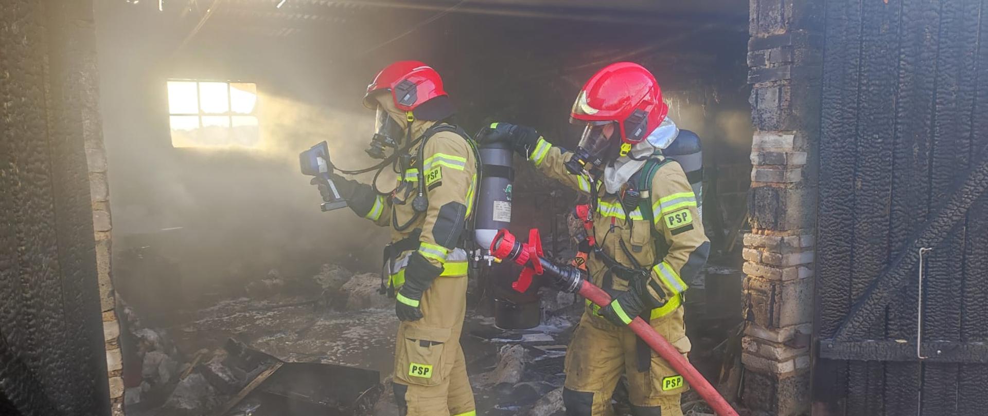 Na zdjęciu widać rotę dwóch strażaków w aparatach ochrony dróg oddechowych podczas wykonywania pomiaru kamerą termowizyjną 