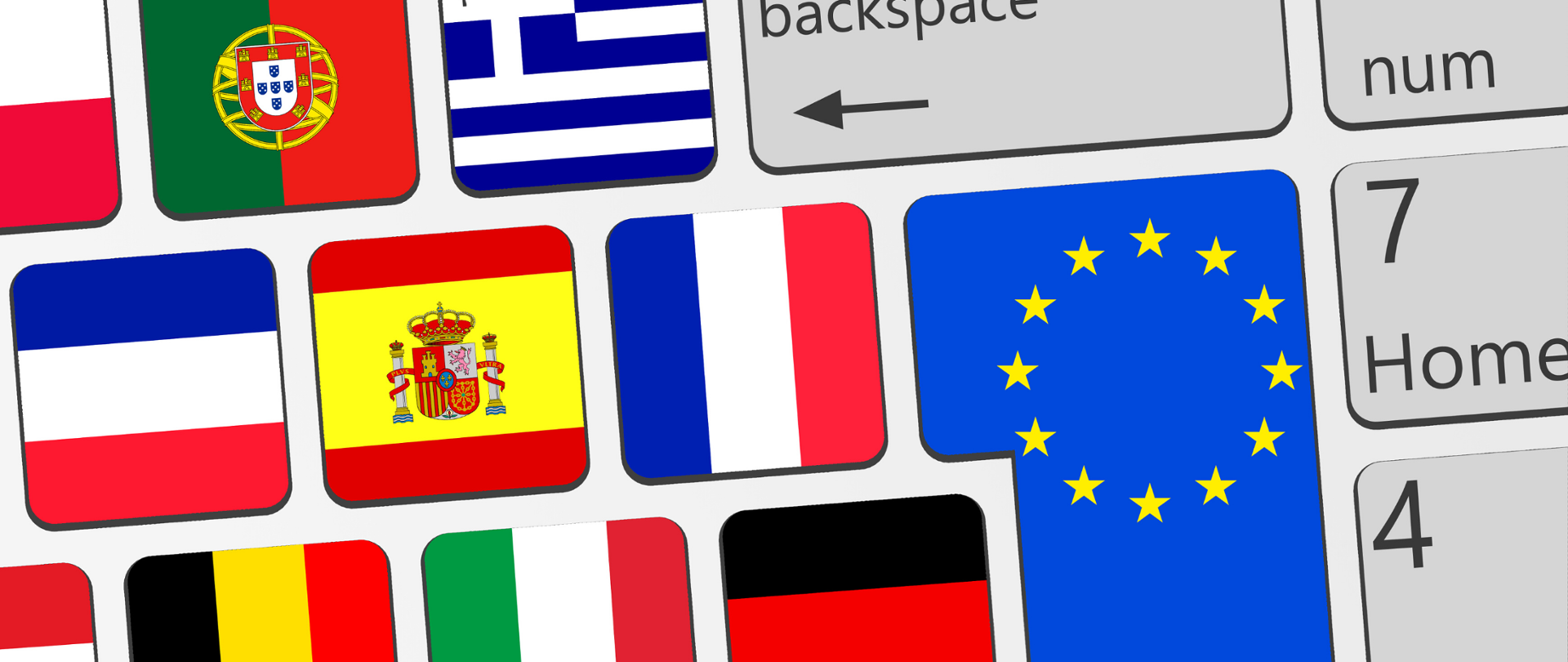 Biała klawiatura komputera. Na poszczególnych przyciskach flagi krajów Unii Europejskiej i Unii Europejskiej.