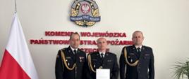 Na zdjęciu stoją Zachodniopomorski Komendant Wojewódzki PSP st. bryg. Mirosław Pender, po jego lewej stronie powołany na stanowisko zastępcy Komendanta Powiatowego PSP w Wałczu kpt. Grzegorz Brusiło. Dalej po lewej st. kpt. Marcin Kulczyk, Komendant Powiatowy PSP w Wałczu. Wszyscy w umundurowaniu galowym.